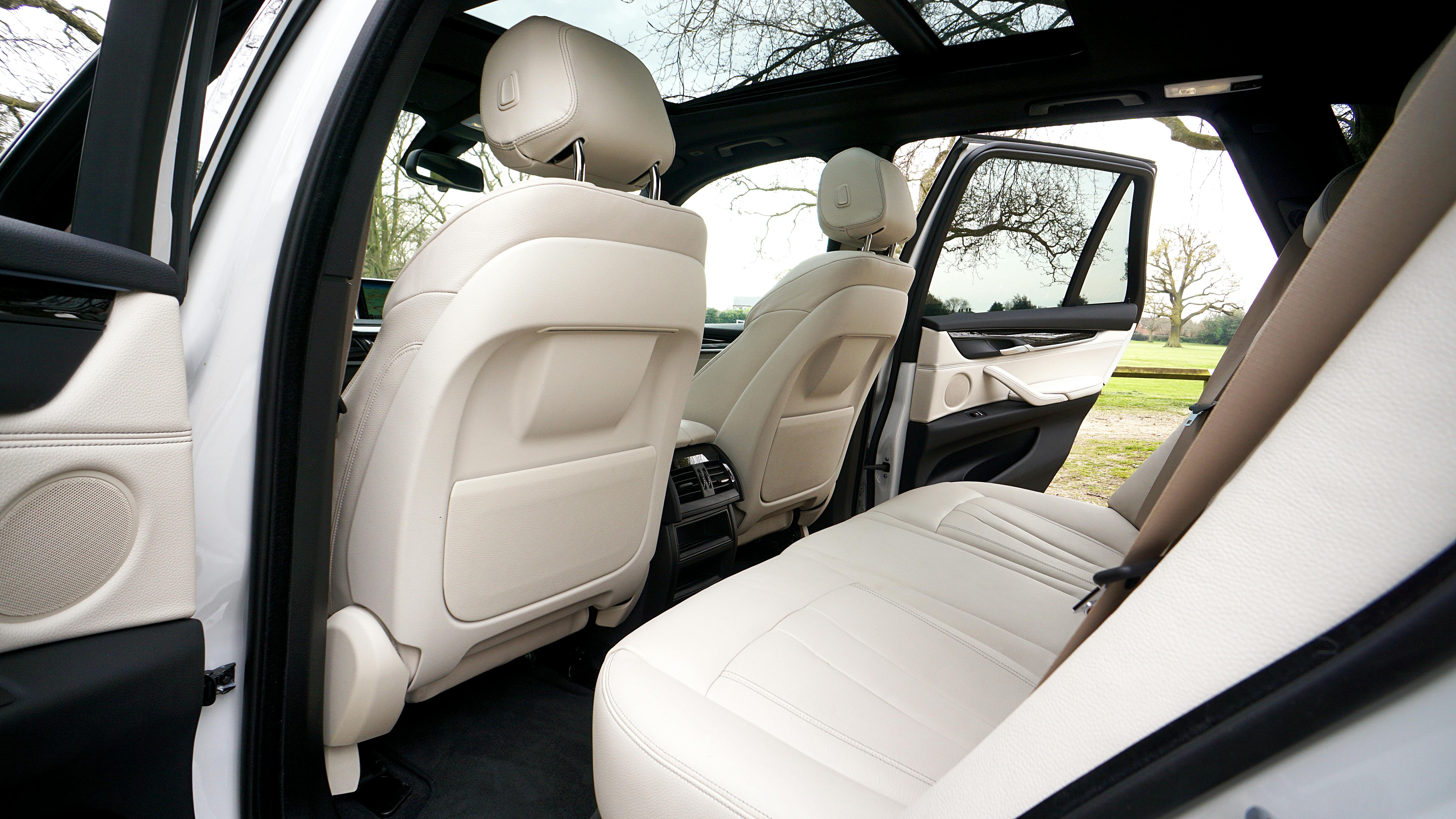 2026 BMW X5 rear cabin – spacious second row with sliding seats, ideal for car seats and growing children in NYC family use